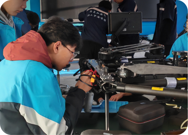 Trainees practicing drone equipment maintenance